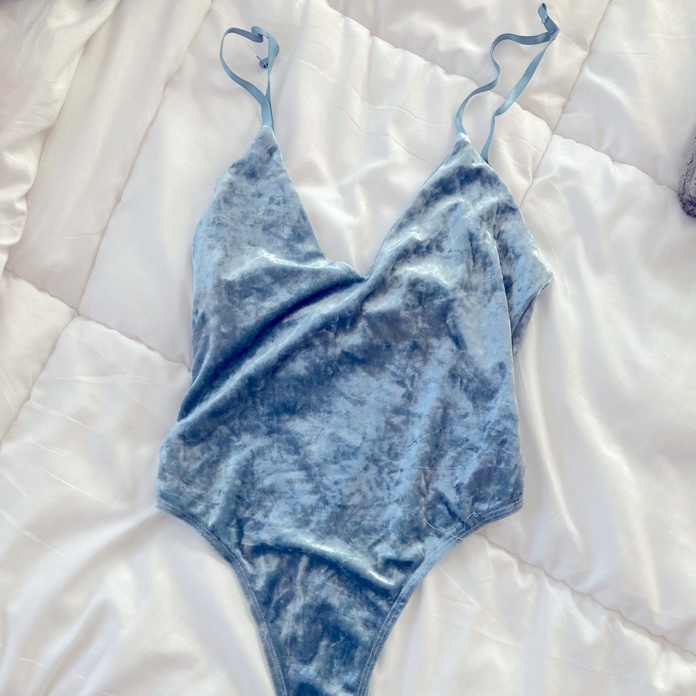 Small “satin” feeling and looking baby blue/azul body suit.